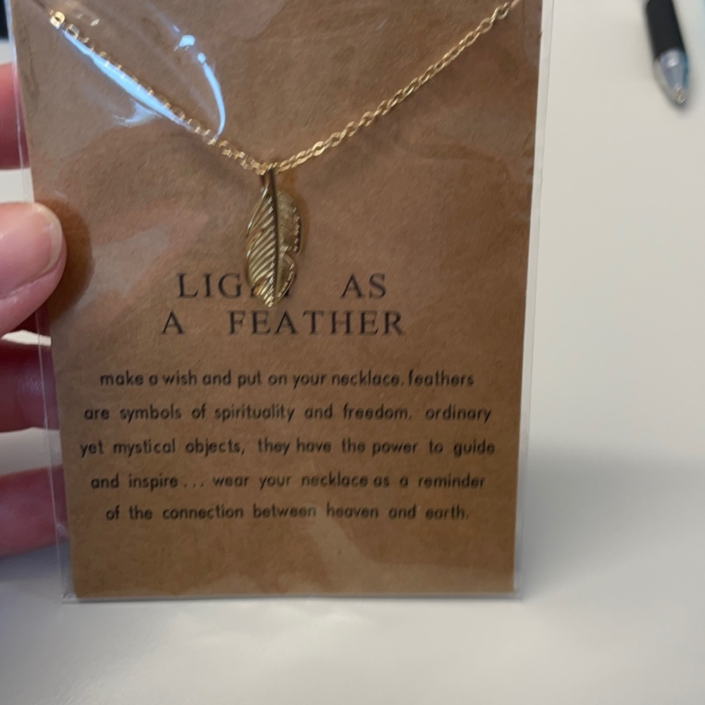 Gold tone feather necklace